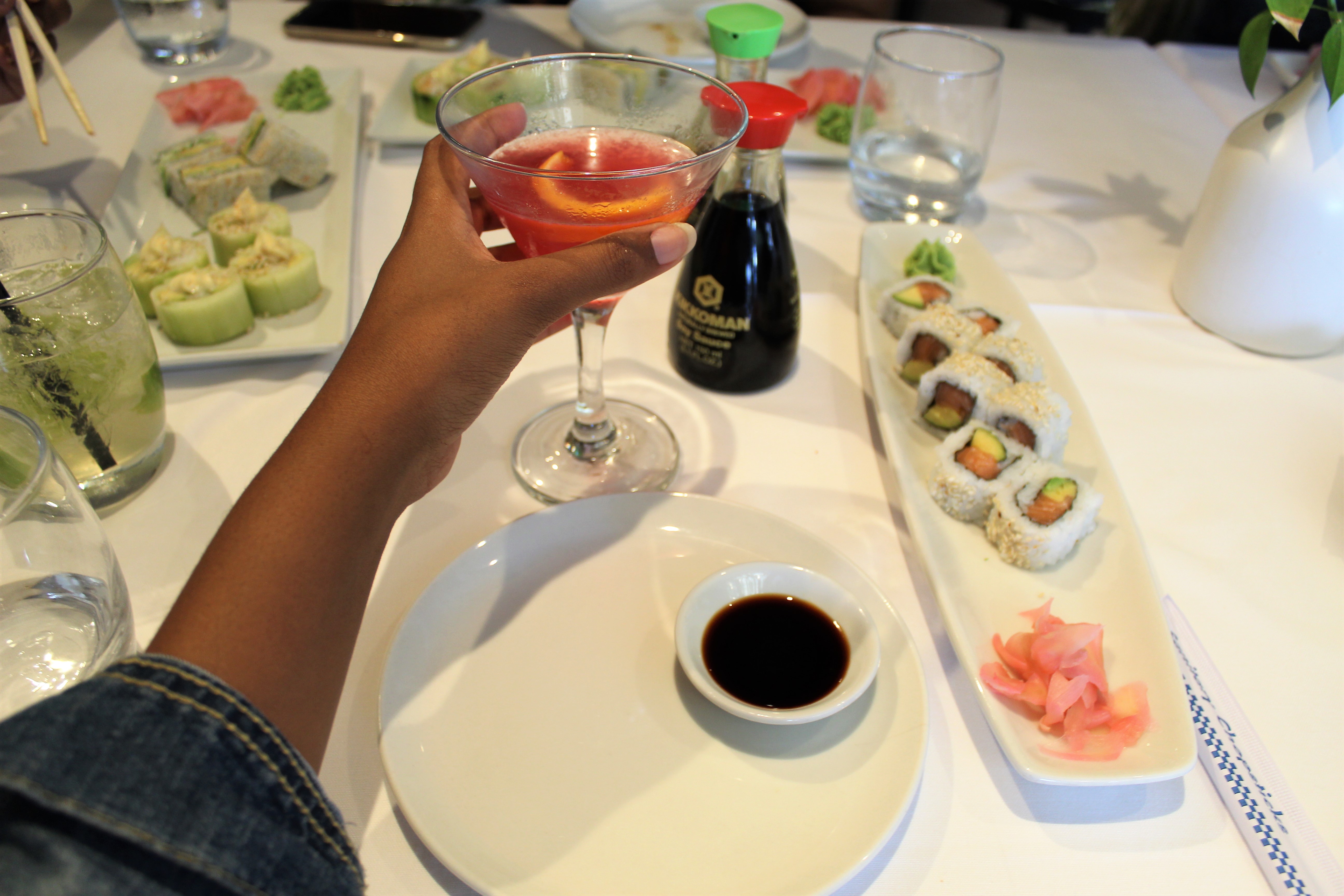 sushi platter with soy sauce and pink cosmopolitan cocktail